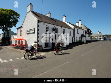 Cushendun village with two touring cyclists Stock Photo