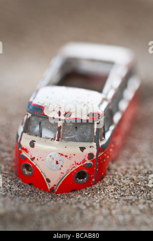 An old model of a campervan or bus stuck in sand Stock Photo