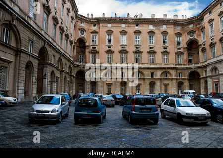 A courtyard used as a car park in The Royal Palace of Caserta, a former royal residence in Caserta Stock Photo