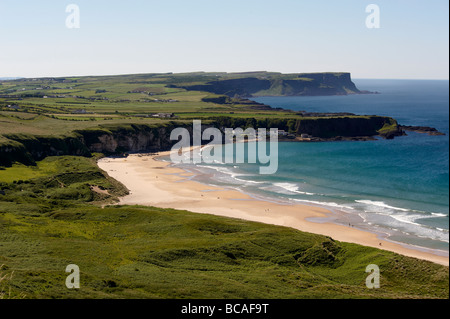 White Park Bay with the small fishing village of Portbradden at the western end of the beach, part of the north Antrim coast. Stock Photo