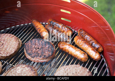 Hamburgers and hot dogs on the barbecue Stock Photo