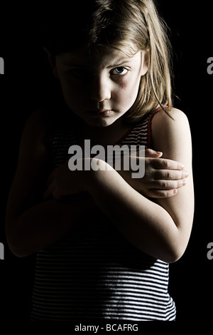 Low Key Shot of a Frightened Looking Child Stock Photo