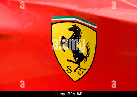 red ferrari logo on formula one motor racing car Stock Photo