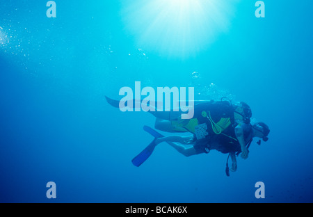 A boyfriend and girlfriend explore together as scuba diving buddies. Stock Photo