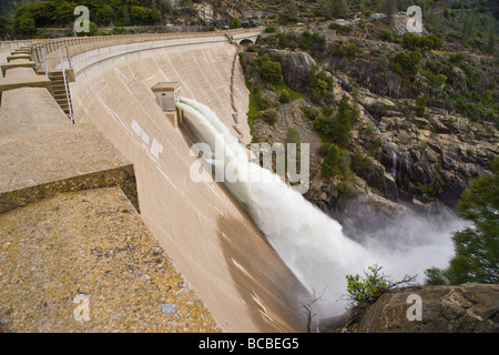 The O'Shaughnessy Dam in Yosemite National Park spills water through several sluice gates. Stock Photo