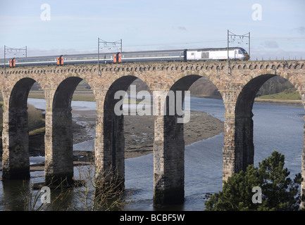 A National Express train travelling over the Royal Border Bridge on the East Coast Main Line between London and Scotland Stock Photo