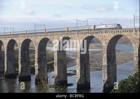 A National Express train travelling over the Royal Border Bridge on the East Coast Main Line between London and Scotland Stock Photo