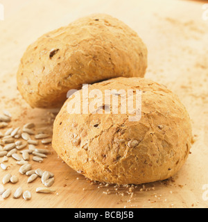 Two rustic wholemeal bread rolls with sunflower seeds. Stock Photo