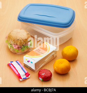Healthy lunch box with wholemeal roll, satsumas / fruit, mini light cheese, orange juice and biscuit and plastic lunch box - school packed lunch Stock Photo