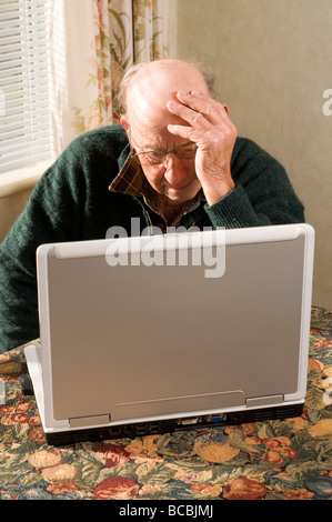 senior man using laptop on table top Stock Photo