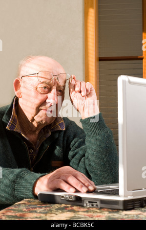senior man using laptop on table top Stock Photo