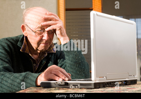 senior man using laptop on table top Stock Photo
