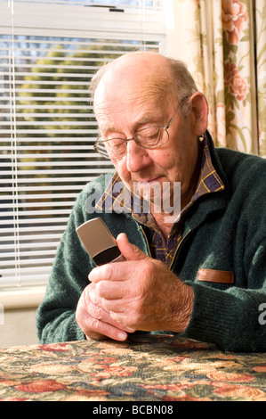 senior man texting mobile phone using Stock Photo