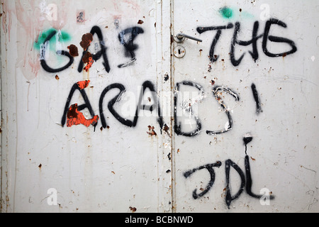 Jewish settler graffiti on the gate of a Palestinian house in the Israeli controlled old city area of Hebron in the West Bank. Stock Photo