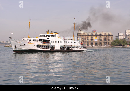 Kadikoy Istanbul passenger ferry boat passes in front of the Haydarpasa railway station on the Asian shore of the city Stock Photo