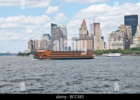 view of Staten Island ferry heading out from post 9.11 lower Manhatten for  Staten Island on a beautiful day Stock Photo