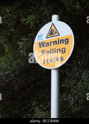 Warning falling rocks sign on cliffs Barry Wales UK Stock Photo