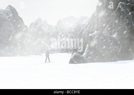 Racing a storm in the high country. Crosscountry skier in a snowstorm Stock Photo