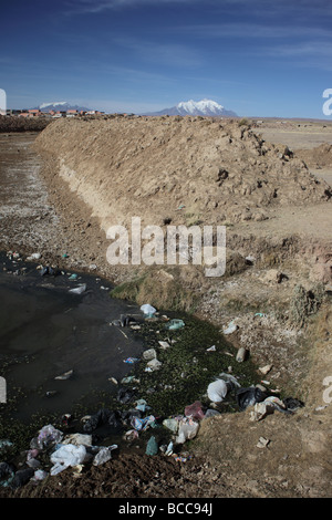 Rubbish in stream, Mt Illimani in background, Viacha, near El Alto, La Paz Department, Bolivia Stock Photo