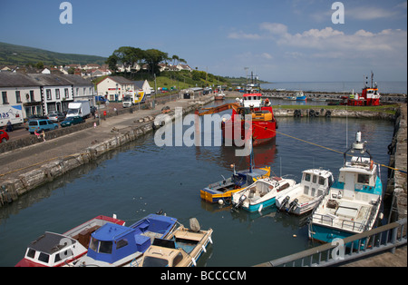 ship containing earth mover dredging carnlough harbour county antrim northern ireland uk Stock Photo