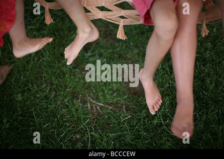High angle view of girls sitting in hammock Stock Photo