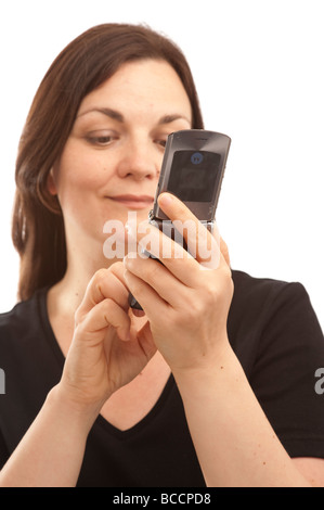 a woman sending a text message on her mobile phone Stock Photo