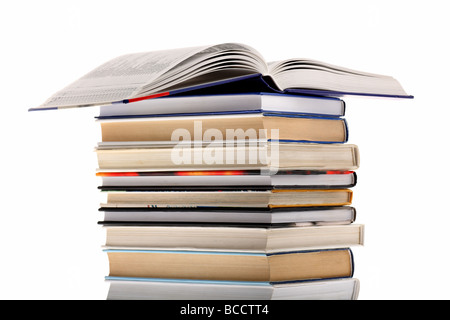 Open dictionary on top of book stack isolated on white background Stock Photo