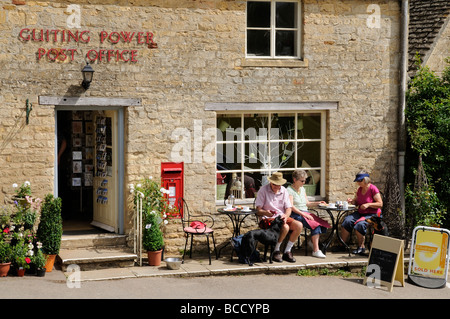 Rural post office and shop at Guiting Power Gloucestershire England UK Customers with dogs on a coffee break Stock Photo