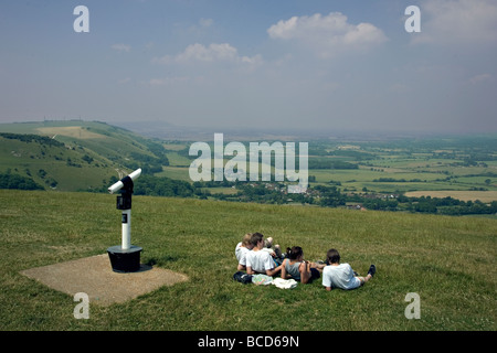 group of young people looking out from Devils dyke on the South Downs in England Stock Photo