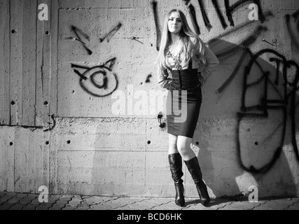 Young woman on graffiti wall background Black and white Stock Photo