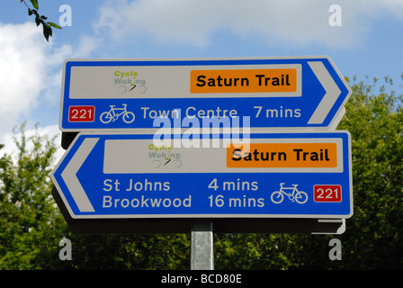 New cycle route signs to St John s Brookwood and Town Centre on the Basingstoke Canal at Langman s Bridge Goldsworth Park Woking Stock Photo