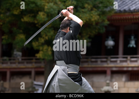 Man holding a real samurai sword during a swordsmanship exercise called ...