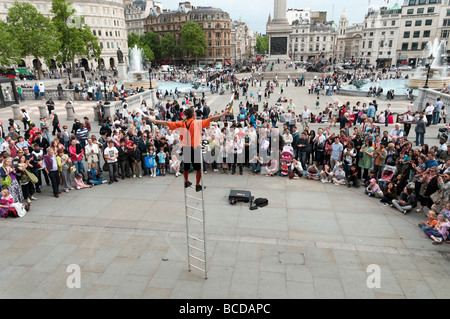 Street entertainer performing in front of public audience in Trafalgar Square London England UK Stock Photo