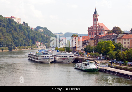 Danube River cruise ships at Passau with St. Paul Church above Stock Photo