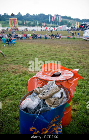 Discarded muddy footwear in bin at Glastonbury Festival, Somerset, UK Stock Photo