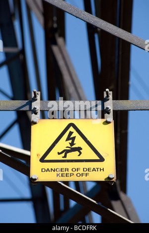 Yellow warning sign on Electricity Pylon reading Danger Of Death Keep Off. Lee Valley nature reserve, Lee Valley, London, UK Stock Photo