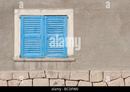 Bright blue window shutters in the small mining town of San Antonio de los Cobres, in northern Argentina. Stock Photo