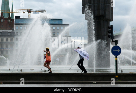 Swedish students running around a fountain in Stockholm, Sweden Stock Photo