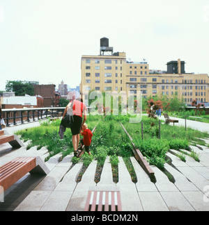 Mother and child walking on iron rails of old railroad explore new High Line Park garden plants in Chelsea Manhattan New York City USA   KATHY DEWITT Stock Photo