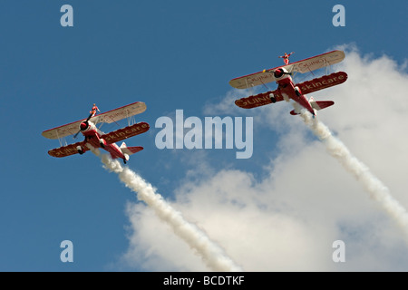 Two Boeing Stearman biplanes from Team Guinot perform their wingwalking feats at the Biggin Hill Airshow 2009. Stock Photo