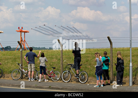 Enthusiasts watch the BAE Hawk aircraft of the RAF's aerobatic team 'The Red Arrows' at Biggin Hill, England, UK. Stock Photo