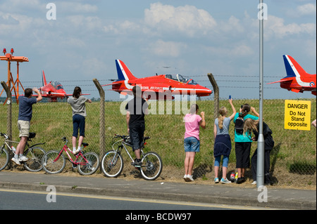 Enthusiasts watch the BAE Hawk aircraft of the RAF's aerobatic team 'The Red Arrows' at Biggin Hill, England, UK. Stock Photo