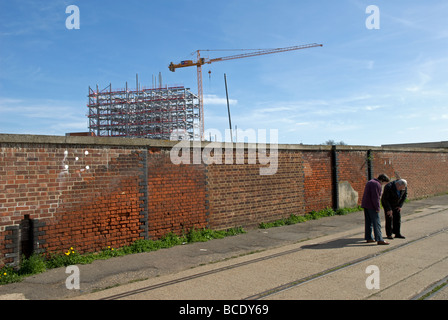 People looking at the old railway tracks where redevelopment is taking place, Ipswich, Suffolk, UK. Stock Photo