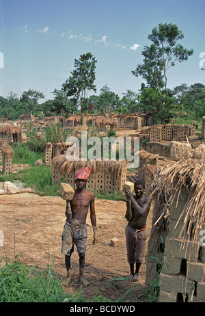 Young black African men working at Brick making factory on Kampala Jinja road Uganda East Africa Stock Photo