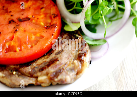 Freshly Grilled Sirloin Beef Steak With A Grilled Tomato Baked Or Jacket Potato And A Green Salad Garnish With No People Stock Photo