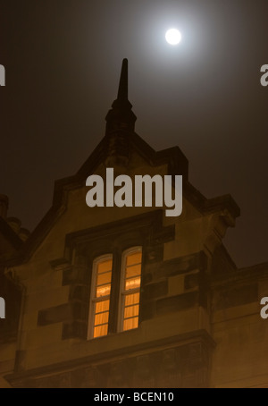 A full moon above a flat on the Royal Mile Edinburgh on a foggy night Stock Photo