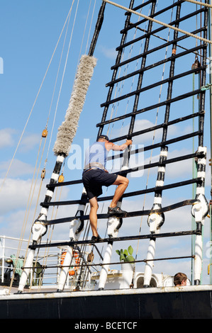 Man climbing shroud on tall ship Kruzenshtern Stock Photo