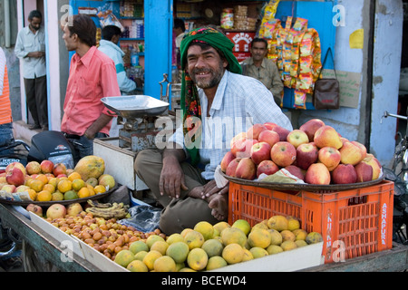 Indian Fruit-seller sits on his fruit-stall. Bhuj, Kutch Region, Gujarat, India Stock Photo