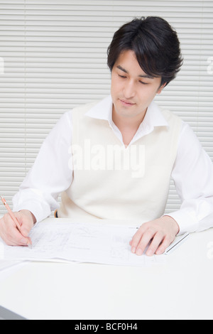 Businessman writing in office Stock Photo