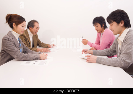 Four people discussing in meeting room Stock Photo